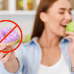 Woman eating apple, holding donut away in rejection