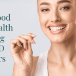 Woman flossing her teeth smiling, text that says "Why Good Oral Health During COVID Matters"