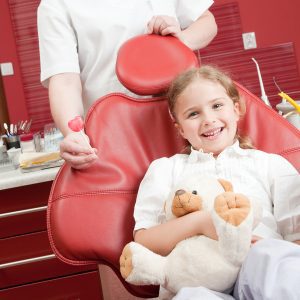 Little girl happy in a dental chair